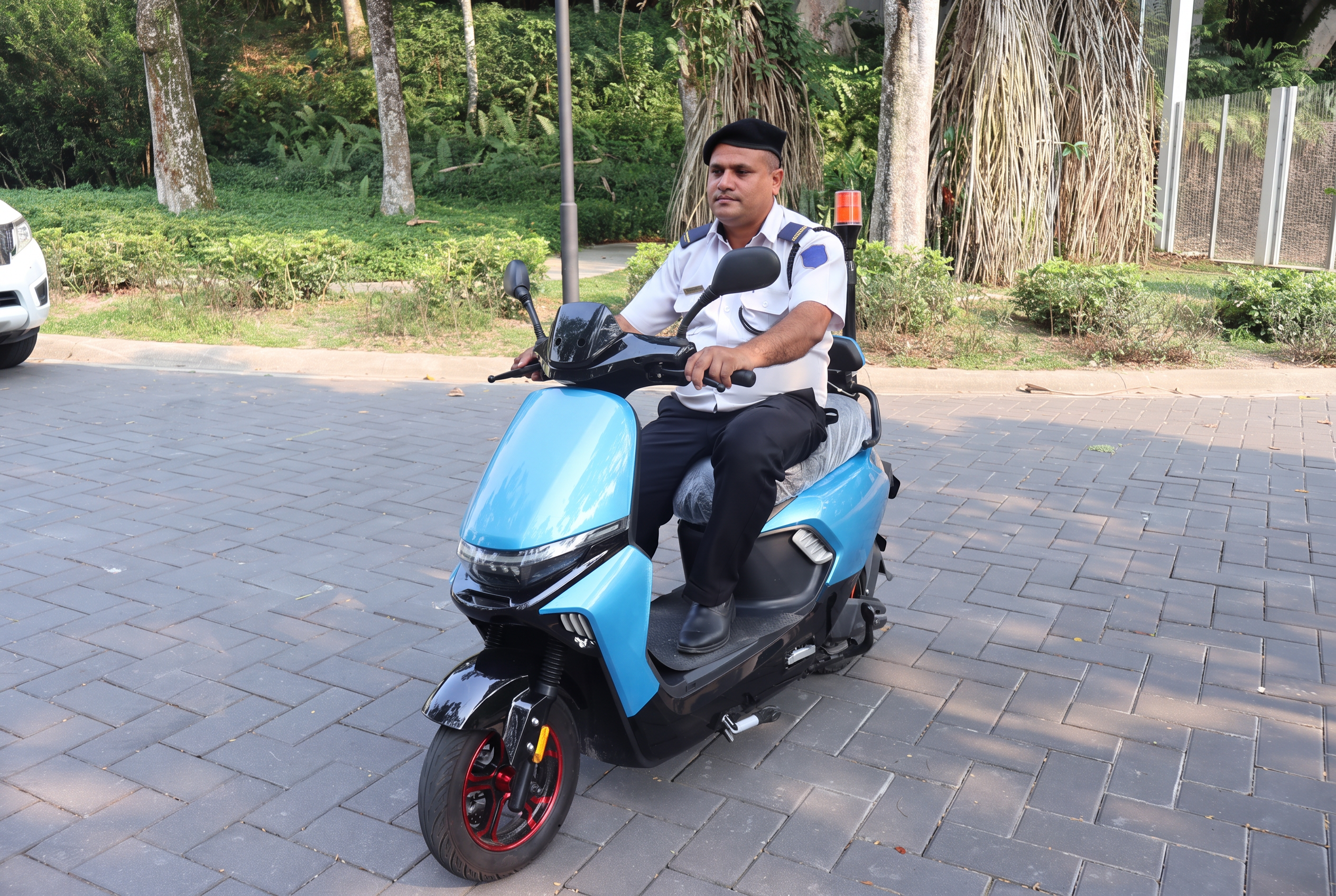 Security officer on a patrol scooter outside a residential development