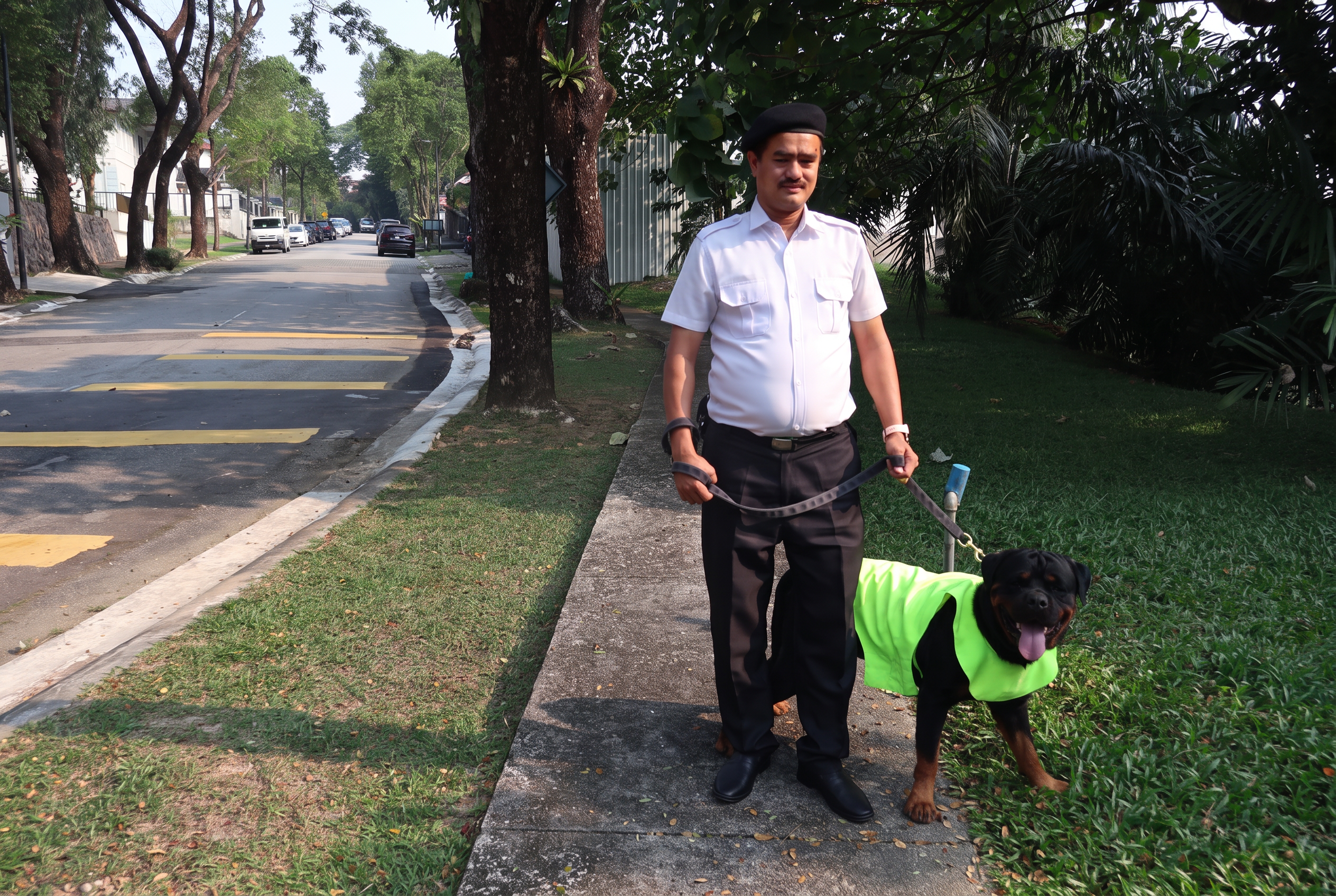 Uniformed security officer on patrol with a guard dog