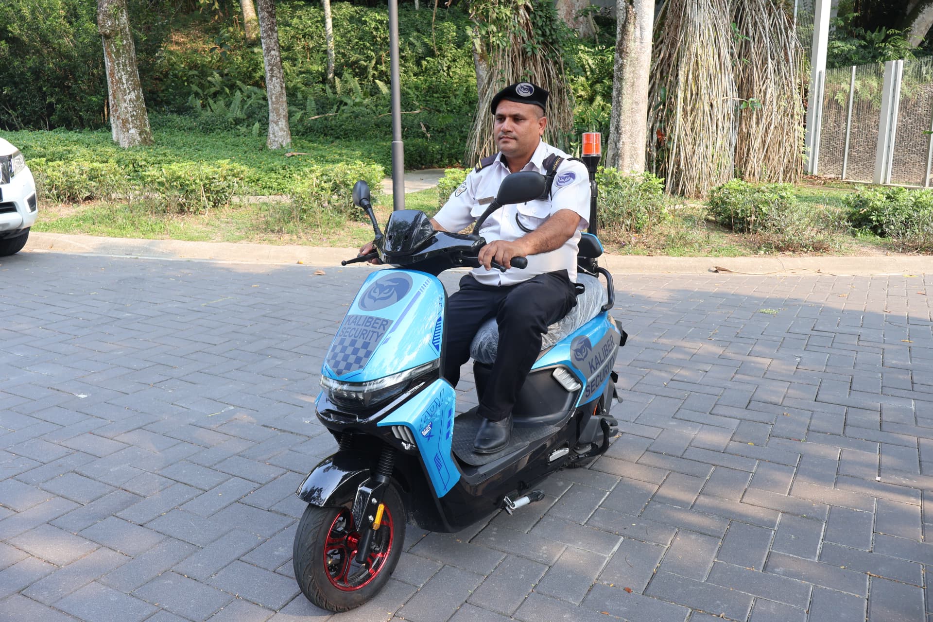 Security officer on a patrol scooter outside a residential development