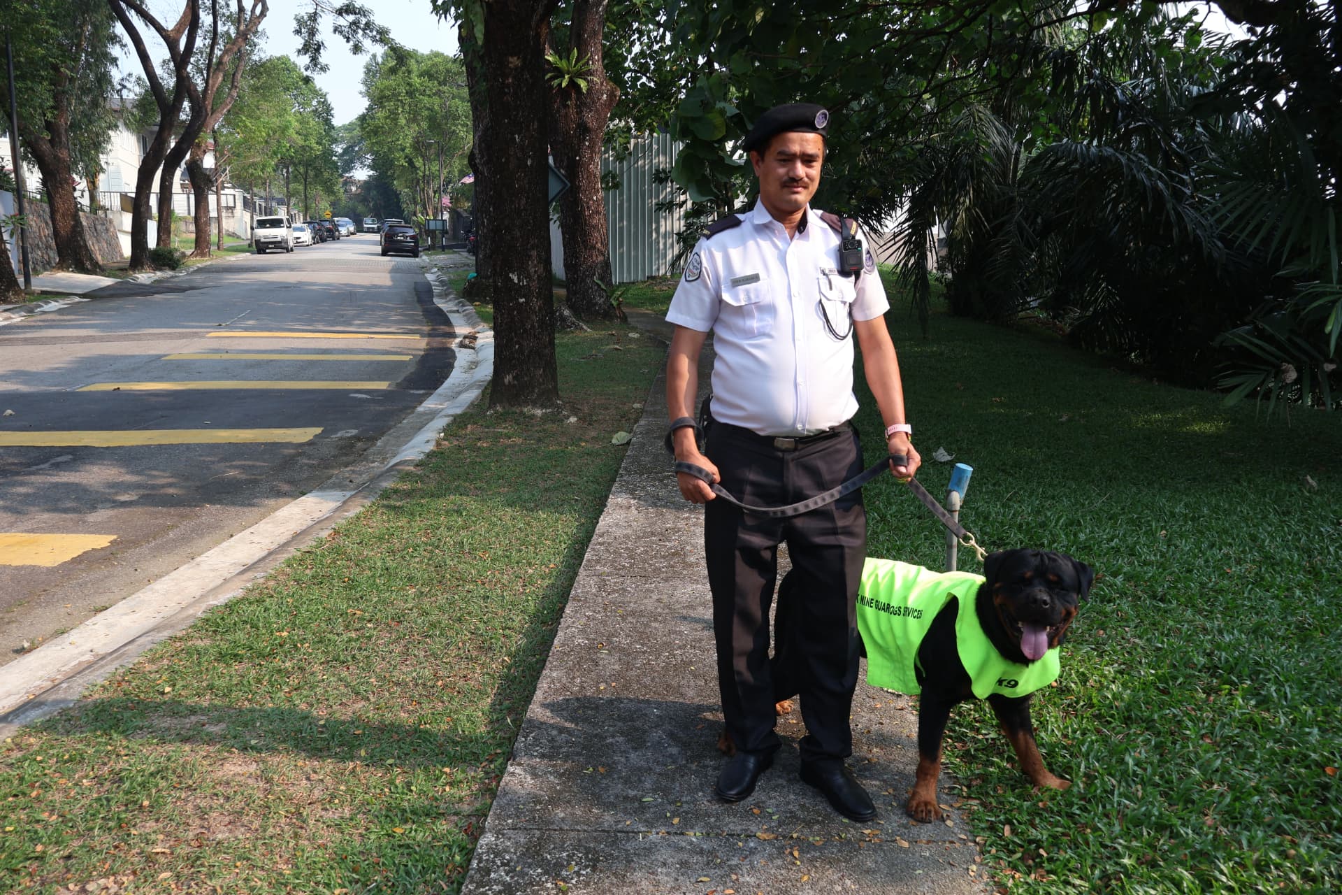 Uniformed security officer on patrol with a guard dog
